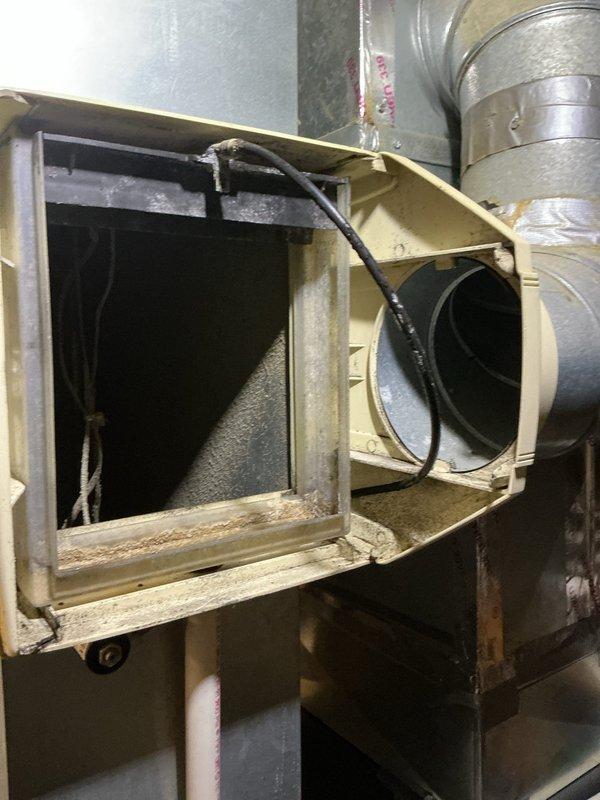 Completed standard air conditioning tune-up on approximately 8-year-old outdoor condensing unit. Performed comprehensive system inspection, accessed air handler unit to examine blower assembly and filter condition, documented accumulated debris on mesh filter indicating need for maintenance, and verified proper operation of all HVAC components including ductwork connections and electrical wiring.