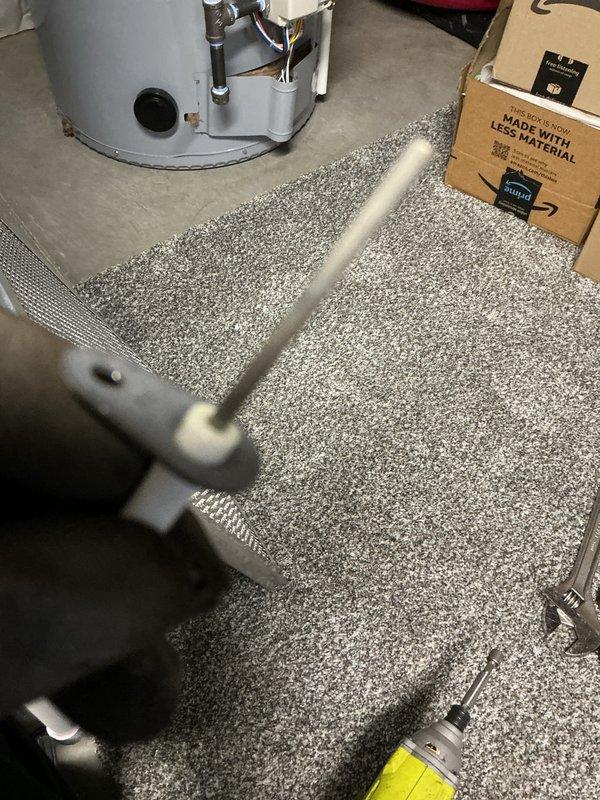 Completed routine heating maintenance visit on a 3-year-old system. Performed electrical diagnostics using multimeter, confirmed proper voltage readings at 120V, and inspected HVAC equipment including associated plumbing connections and water heater components in the utility area.