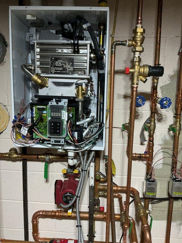 Completed annual heating tune-up on wall-mounted tankless boiler system with multi-zone distribution. Technician noted recurring heat exchanger failure requiring annual replacement, as reported by homeowner. Performed standard maintenance inspection of unit, verified operation of circulator pump, tested zone valves and brass fittings throughout copper piping network, and confirmed proper function of control panel and digital displays.