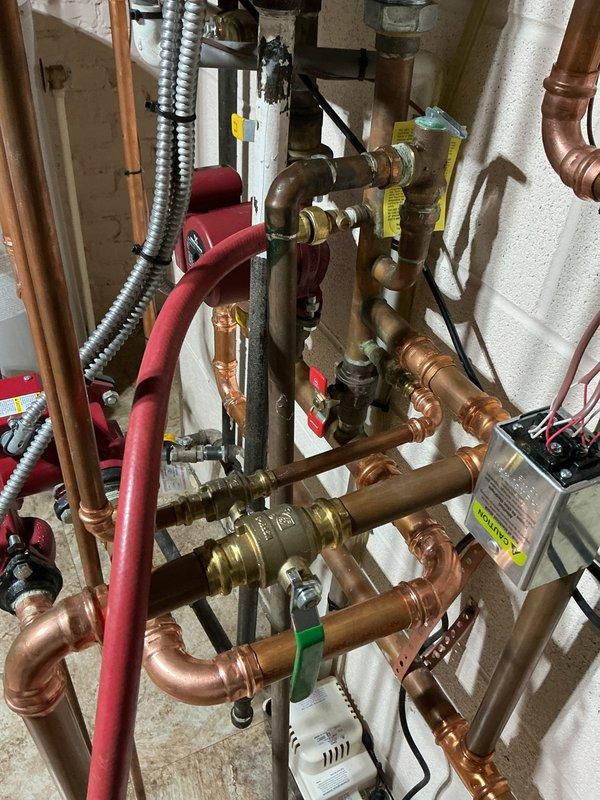 Completed annual heating tune-up on wall-mounted tankless boiler system with multi-zone distribution. Technician noted recurring heat exchanger failure requiring annual replacement, as reported by homeowner. Performed standard maintenance inspection of unit, verified operation of circulator pump, tested zone valves and brass fittings throughout copper piping network, and confirmed proper function of control panel and digital displays.