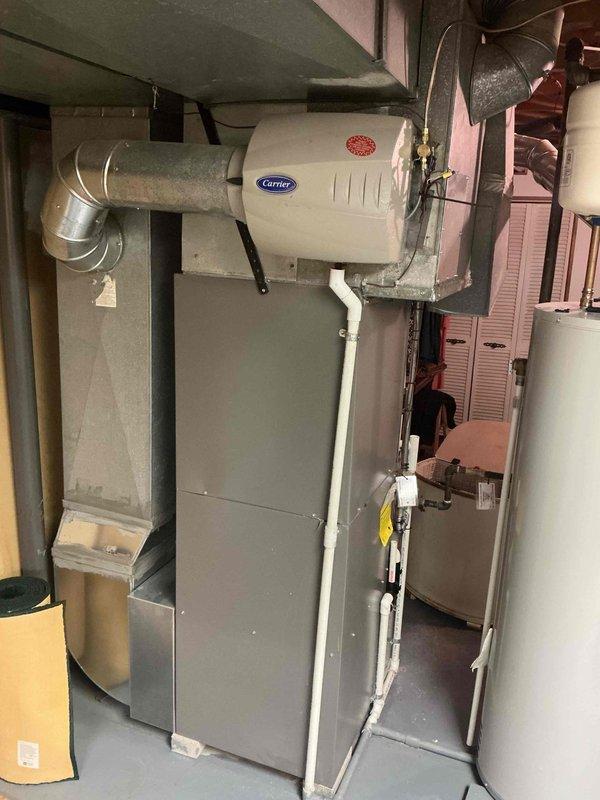 Responded to service call for ticking noise reported after routine tune-up. Inspected furnace, blower assembly, and humidifier installation for loose components, debris, or mechanical interference. Verified all mounting hardware secure, checked ductwork connections, and examined humidifier solenoid and motor operation. System operating within normal parameters with no abnormal sounds detected during inspection.
