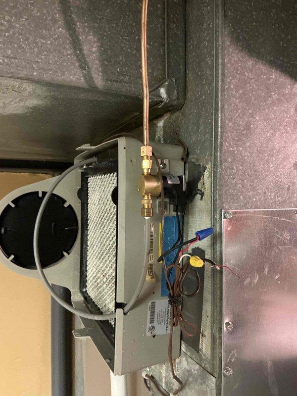 Responded to service call for ticking noise reported after routine tune-up. Inspected furnace, blower assembly, and humidifier installation for loose components, debris, or mechanical interference. Verified all mounting hardware secure, checked ductwork connections, and examined humidifier solenoid and motor operation. System operating within normal parameters with no abnormal sounds detected during inspection.