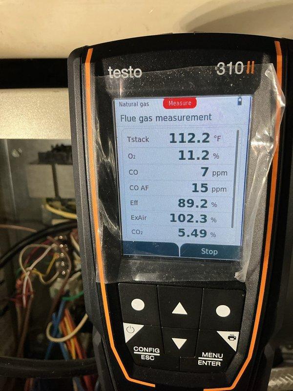 Completed Maintenance MVP HEAT service on an 11-year-old natural gas furnace. Performed comprehensive system inspection and combustion analysis using calibrated flue gas analyzer. Combustion testing revealed stack temperature of 112.2°F, oxygen level of 11.2%, carbon monoxide reading of 7 ppm in flue gas with 15 ppm air-free CO, system efficiency of 89.2%, excess air at 102.3%, and carbon dioxide level of 5.49%. All combustion parameters fall within acceptable operating ranges for safe and efficient furnace operation. Inspected air handler cabinet, ductwork connections, and PVC condensate drain system. Verified proper operation of all furnace components and confirmed unit is functioning as designed. System documented with photographic evidence showing equipment condition and analyzer readings.