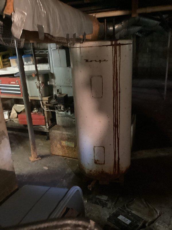 Conducted comprehensive assessment of existing residential heating system in preparation for furnace replacement estimate. Evaluated current furnace unit, an older model gas-fired system showing signs of age and wear, along with associated ductwork, venting, and utility connections. Documented existing equipment configuration including flexible ductwork distribution, gas line connections with shutoff valve, PVC condensate drainage, and electrical service. Assessed installation space constraints in basement utility area and measured clearances for new equipment placement. Photographed current system components, connections, and surrounding mechanical room layout to develop accurate replacement specifications and ensure proper sizing for new furnace installation.