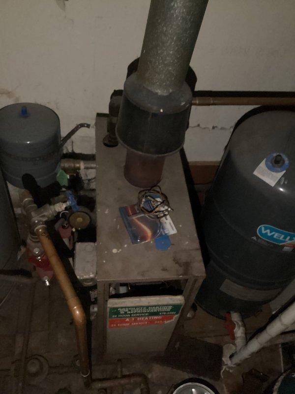 Conducted comprehensive site assessment of existing boiler system in basement mechanical room to provide replacement estimate. Evaluated current hydronic heating system including boiler unit, expansion tanks, copper piping distribution network, and associated safety valves and controls. Documented existing equipment configuration, including Well-X-Trol expansion tank, supply and return piping arrangements, and ductwork connections. Photographed installation to capture current system layout, component conditions, and spatial constraints for accurate replacement planning and equipment sizing recommendations.
