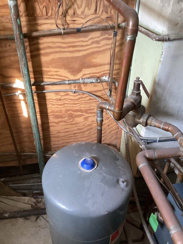 Conducted on-site assessment of existing HVAC system for mini split installation estimate and evaluated current boiler system for potential replacement. Documented existing equipment including aging boiler with galvanized hood assembly, pressure tank with copper piping network, and associated mechanical components. Provided estimate options for mini split system installation and boiler replacement, including alternative solution utilizing combination water heater/boiler unit to improve system efficiency and functionality.