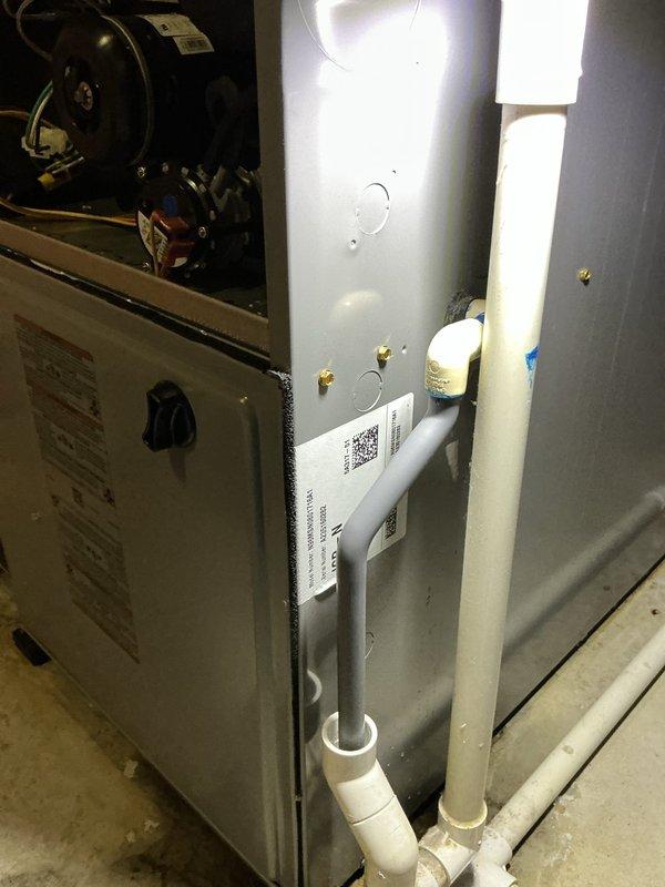 Responded to callback for furnace leak issue following previous no-heat service call where improper AC installation prevented furnace operation. Upon inspection, identified condensate drainage system improperly configured during July AC installation. Corrected PVC condensate line routing and connections to prevent water leakage when furnace operates. Verified proper drainage flow, tested system operation through complete heating cycle, and confirmed no leaks present. System now functioning correctly with proper condensate management.