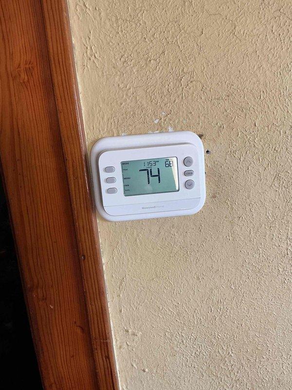 Returned to property to replace malfunctioning thermostat with new Honeywell Home digital programmable unit from truck stock. Removed old thermostat, connected wiring to appropriate terminals on new unit, mounted device to wall, and verified proper system operation with successful temperature display and control functionality.