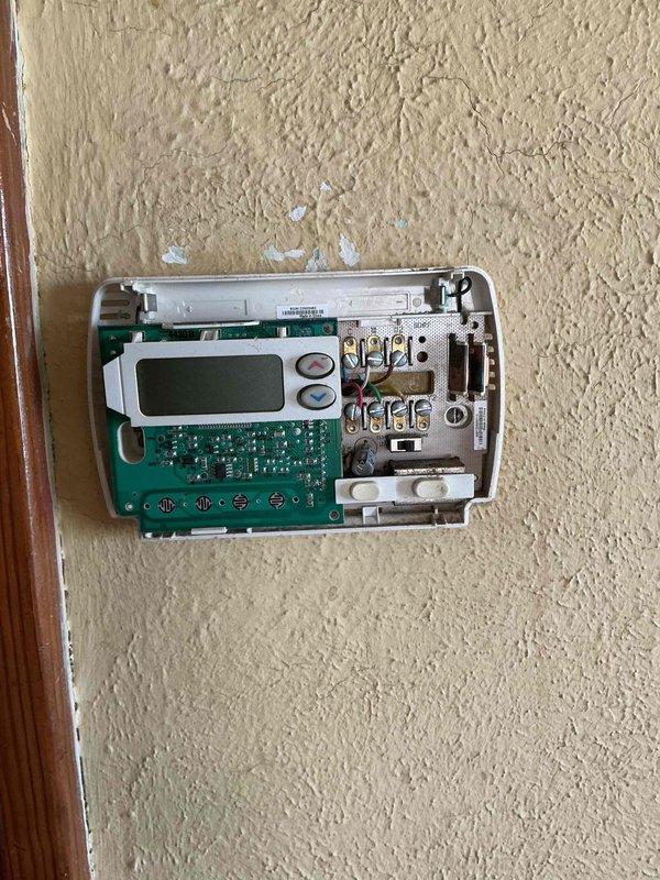 Returned to property to replace malfunctioning thermostat with new Honeywell Home digital programmable unit from truck stock. Removed old thermostat, connected wiring to appropriate terminals on new unit, mounted device to wall, and verified proper system operation with successful temperature display and control functionality.