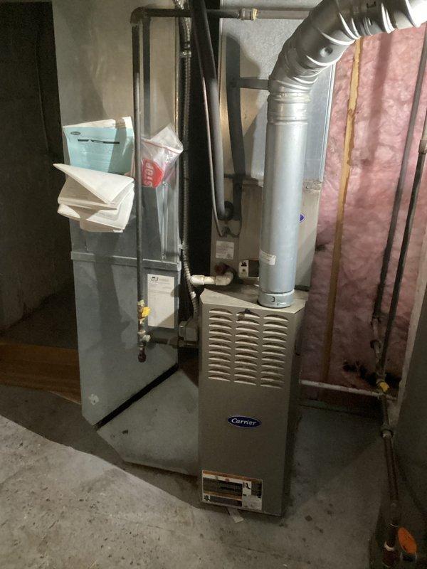 Completed comprehensive estimate for full HVAC system replacement including indoor furnace unit and outdoor condensing unit. Evaluated existing Carrier furnace located in basement mechanical room along with current outdoor condenser positioned on concrete pad against building foundation. Assessed ductwork configuration, refrigerant line routing, electrical connections, and equipment placement for replacement specifications. Documented current system layout and captured detailed photos of both indoor and outdoor equipment to provide accurate replacement proposal.