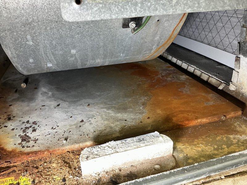 Responded to service call for commercial furnace experiencing cycling issues and intermittent shutdowns during heating operation. Upon arrival, performed diagnostic inspection of unit and identified significant water accumulation in condensate drain pan with extensive rust staining and sediment buildup. The corroded drain pan showed evidence of prolonged moisture exposure with standing water containing rust-colored discoloration and debris throughout the collection tray. Documented existing conditions showing compromised drainage system and deteriorating metal surfaces. The unit's base interior displayed accumulated dirt, sediment, and oxidation indicating maintenance concerns affecting proper condensate removal. Addressed immediate cycling concern and provided customer with findings regarding drain pan condition and recommended corrective actions to prevent future operational issues.