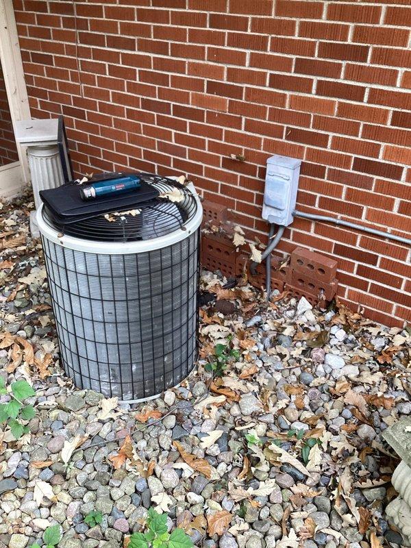 Conducted comprehensive evaluation of existing HVAC system for complete replacement of furnace and air conditioning unit. Assessed current basement-installed furnace with existing ductwork configuration, PVC venting system, and connected humidifier component to determine replacement specifications. Evaluated outdoor condenser unit positioned against exterior brick wall, including electrical disconnect box and refrigerant line routing. Documented equipment specifications, system layout, and installation requirements through detailed photography to provide accurate replacement estimate for complete heating and cooling system upgrade.