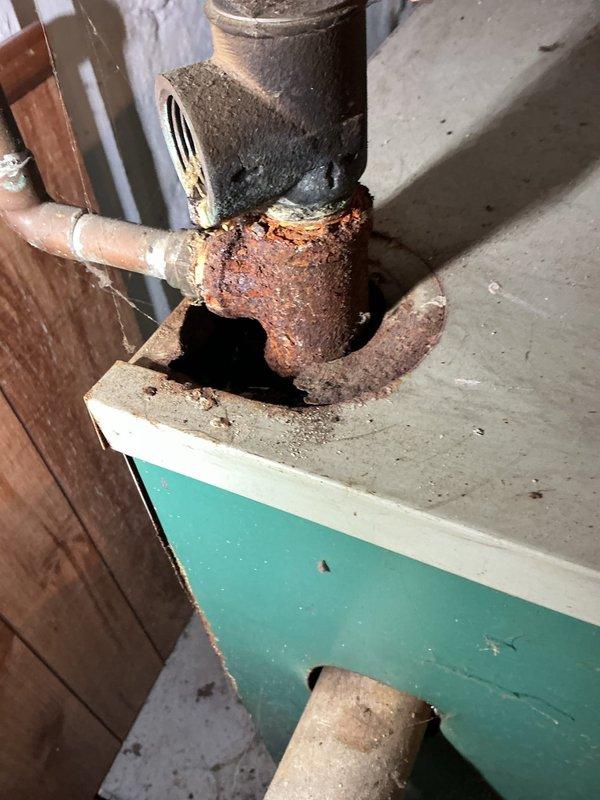 Completed comprehensive boiler tune-up and system inspection. Upon examination, discovered severely corroded plumbing connections with extensive rust buildup on elbow joints and fittings, indicating prolonged moisture exposure. Heat exchanger inspection revealed significant deterioration with multiple vertical cracks, heavy soot accumulation, and structural compromise requiring immediate attention and potential replacement to prevent carbon monoxide hazards. Documented all findings with photographic evidence for customer review and safety recommendations.