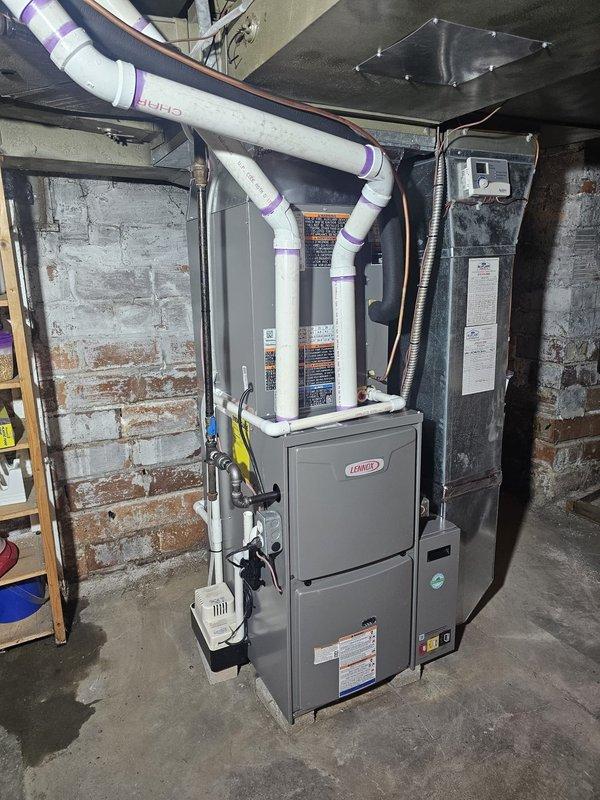 # Complete HVAC System Installation

Performed a complete residential HVAC system installation consisting of an upflow 96% efficiency 70,000 BTU gas furnace with matching upflow cased evaporator coil in the basement mechanical room. Installed a metal 5-inch filter rack for enhanced air filtration capacity. Mounted a 13 SEER single-stage air conditioning condenser on a new equipment pad on the exterior of the residence with proper gravel base for drainage and vibration dampening.

Ran new 3/4-inch refrigerant lineset spanning 25 feet from the outdoor condensing unit through the foundation to connect with the indoor evaporator coil, ensuring proper refrigerant flow and system efficiency. Installed new electrical disconnect and whip at the outdoor unit to meet code requirements for service accessibility. Configured all PVC condensate and combustion air/vent piping from the high-efficiency furnace, routing through the basement ceiling to appropriate termination points on the building exter