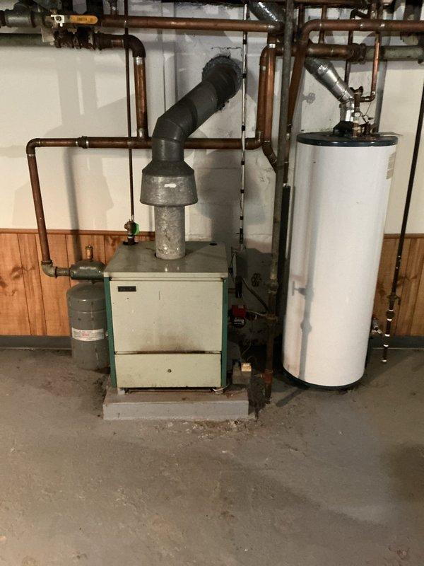 Responded to service call for boiler system operating at elevated pressure of 35 PSI, exceeding the recommended 20 PSI setpoint and entering high-risk zone. Performed system inspection and diagnostics on residential boiler installation, including examination of expansion tank, pressure relief components, and associated hydronic piping network. Documented current system conditions with photographic evidence showing boiler unit, expansion tank, water heater, and copper distribution piping configuration in basement mechanical room.