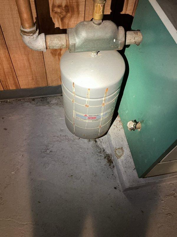 Responded to service call for boiler system operating at elevated pressure of 35 PSI, exceeding the recommended 20 PSI setpoint and entering high-risk zone. Performed system inspection and diagnostics on residential boiler installation, including examination of expansion tank, pressure relief components, and associated hydronic piping network. Documented current system conditions with photographic evidence showing boiler unit, expansion tank, water heater, and copper distribution piping configuration in basement mechanical room.