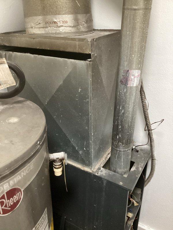 Completed comprehensive assessment of existing HVAC system for furnace replacement estimate. Inspected aging furnace unit showing significant dust accumulation and wear, along with associated ductwork connections including metal plenum assemblies and flexible insulation-wrapped ducts. Documented current equipment condition, ductwork configuration, and mechanical room layout to provide accurate replacement specifications and installation requirements.