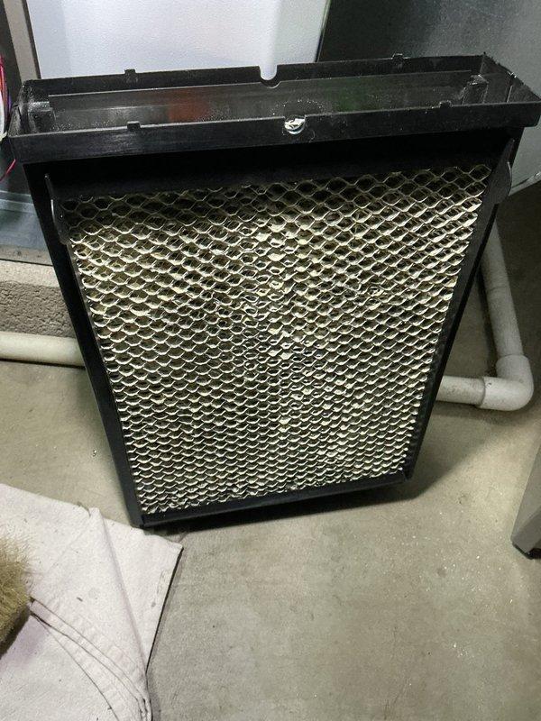 Completed routine maintenance tune-up on a 2-year-old furnace system. Inspected and serviced the air filtration unit, which included examining the honeycomb mesh filter media and internal filtration components housed in the black metal frame assembly. All system components were found to be operating within normal parameters for a unit of this age.