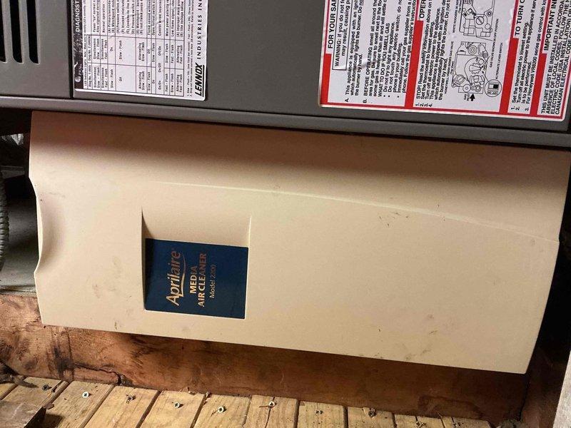 Performed a seasonal tune-up on an 18-year-old Lennox gas furnace with an attached Aprilaire Model 2200 media air cleaner, accessed via ladder in the attic. Conducted a combustion analysis with a Testo 310 II flue gas analyzer on natural gas, recording a stack temperature of 287.8°F, 11.0% O2, 5.60% CO2, 9 ppm CO (19 ppm air-free), and 81.5% efficiency with 98.5% excess air, confirming safe CO levels and operation within acceptable range.