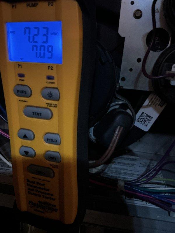 Performed annual maintenance on a 19-year-old gas furnace, verifying system operation and checking static pressure with a dual-port manometer (7.23 inWC / 7.09 inWC readings) and testing component resistance with a multimeter (33.0 Ω). Confirmed the customer has a furnace-only system and advised that a replacement air filter is needed.