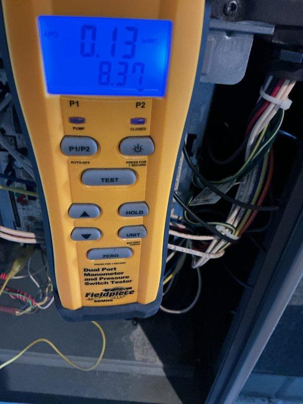 Performed a complete heating tune-up on the basement furnace, including inspection of the gas valve assembly, control wiring, and connections. Verified manifold gas pressure using a dual-port digital manometer, with readings within normal operating range. The system was found operating properly with no deficiencies noted.