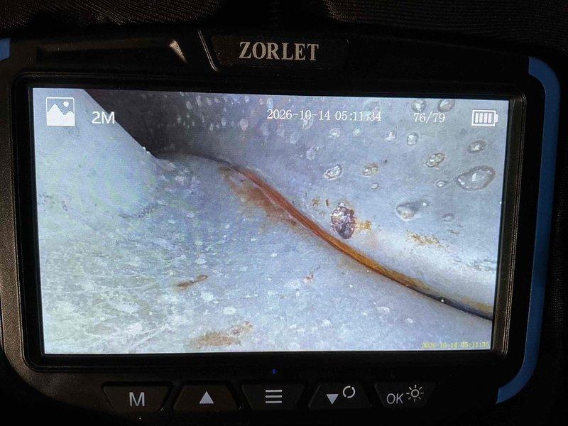 Performed annual heating tune-up and cleaning on a 23-year-old furnace, with the unit operating normally and no reported issues. A borescope inspection of the internal metal surfaces revealed orange-brown rust streaking along seams, pitting, and condensation beads, indicating active corrosion and moisture presence. Recommend further evaluation of the heat exchanger and venting components, as the age of the system and observed corrosion may affect long-term reliability.
