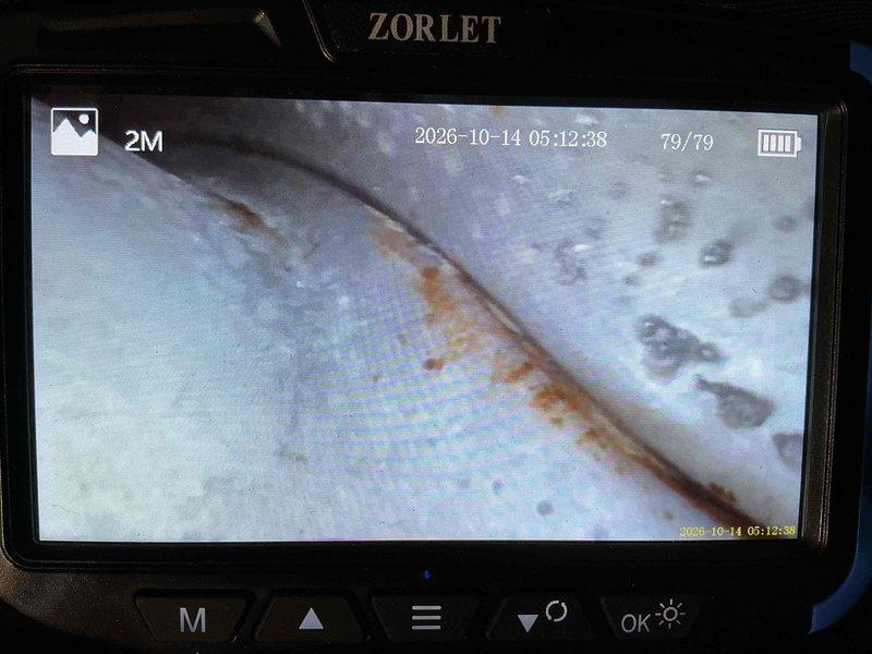 Performed annual heating tune-up and cleaning on a 23-year-old furnace, with the unit operating normally and no reported issues. A borescope inspection of the internal metal surfaces revealed orange-brown rust streaking along seams, pitting, and condensation beads, indicating active corrosion and moisture presence. Recommend further evaluation of the heat exchanger and venting components, as the age of the system and observed corrosion may affect long-term reliability.