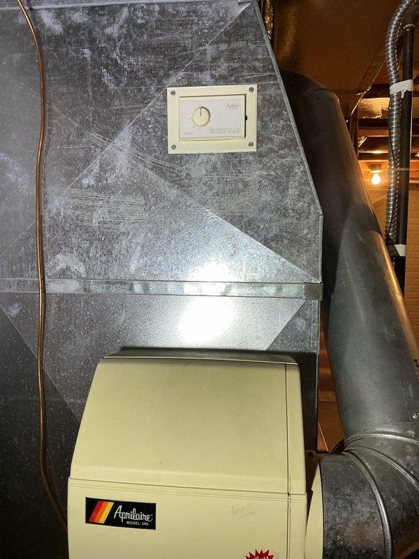 Performed annual maintenance on an 8-year-old basement furnace, including a combustion analysis with a Testo 310 II analyzer under natural gas operation: CO 10 ppm, CO₂ 7.07%, O₂ 8.4%, stack temperature 107.1°F, and 94.0% efficiency, with differential pressure verified at 3.50 inH₂O. Inspected the ductwork and the Aprilaire Model 560 whole-home humidifier and humidistat control, finding no rust, frost, or significant damage.