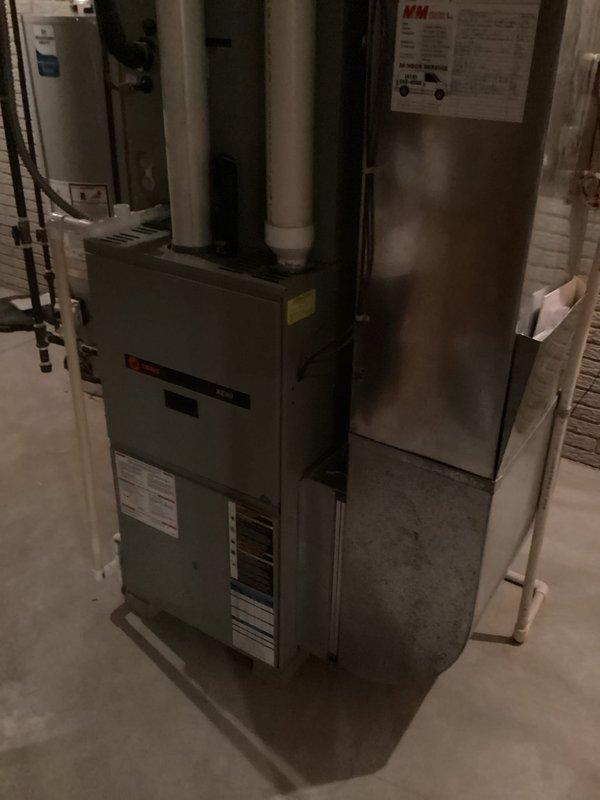 Performed an on-site evaluation for full replacement of two HVAC systems, inspecting the existing Trane gas furnace in the basement utility area, including its PVC venting, plenum and ductwork connections, and condensate drain, and documenting equipment condition and installation layout with photographs. Verified clearances and proximity to the adjacent water heater to determine system sizing and installation requirements for the replacement of both systems.