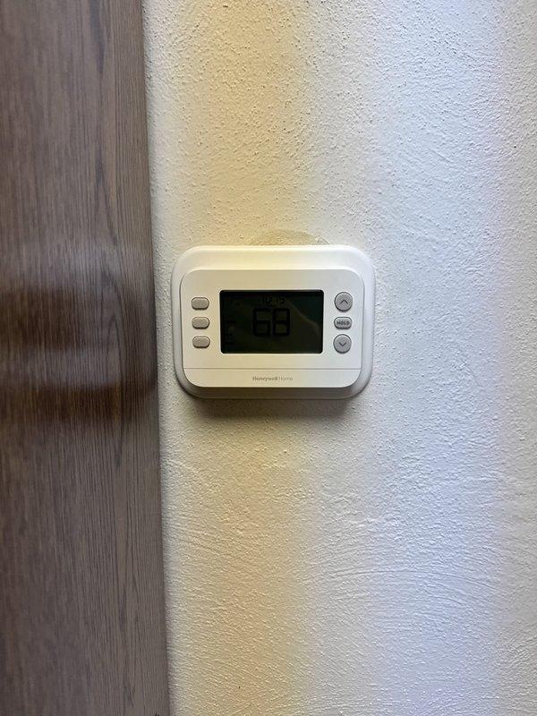 Installed and leveled a commercial gas furnace, verifying proper alignment and connection of the vent piping and equipment cabinet. Mounted and wired a Honeywell Home digital thermostat on the wall, then confirmed control communication and set operation to a 68°F setpoint.