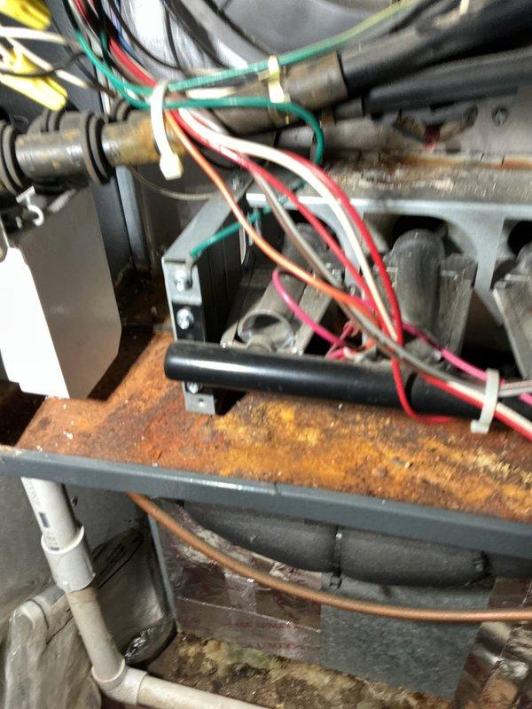 Performed scheduled heating tune-up on a 10-year-old gas furnace under the maintenance agreement, inspecting the burner assembly, wiring harness, control board, transformer, and cabinet interior. Documented heavy rust and corrosion on the burner compartment shelf, the vertical cabinet panel, and the cabinet floor beneath the transformer and wiring, indicating prolonged moisture exposure or leakage. Recommend further evaluation of the moisture source and corroded components to prevent premature failure.