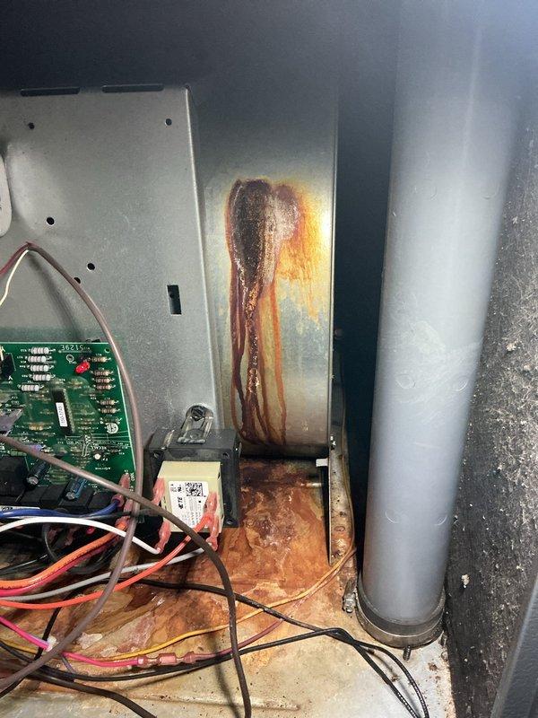 Performed scheduled heating tune-up on a 10-year-old gas furnace under the maintenance agreement, inspecting the burner assembly, wiring harness, control board, transformer, and cabinet interior. Documented heavy rust and corrosion on the burner compartment shelf, the vertical cabinet panel, and the cabinet floor beneath the transformer and wiring, indicating prolonged moisture exposure or leakage. Recommend further evaluation of the moisture source and corroded components to prevent premature failure.