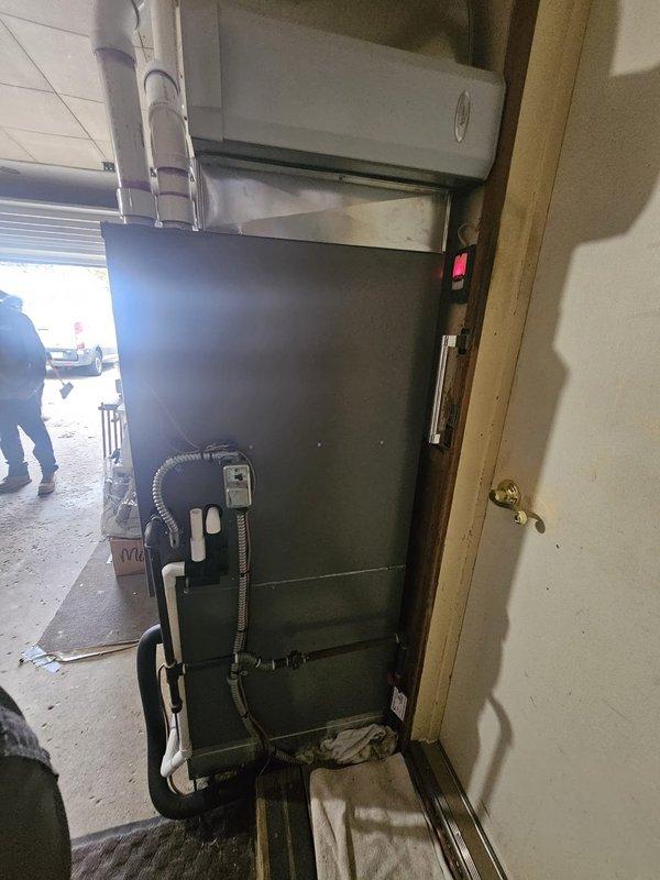 Installed a new complete split system consisting of a 96% AFUE, 90,000 BTU downflow gas furnace with matching cased evaporator coil, metal-supply plenum transition, and a 12-gallon humidifier, with PVC intake/exhaust venting and condensate drain piping routed and secured. Set a new single-stage air conditioning condenser on a new concrete pad and connected it with a new 3/4" x 50' insulated refrigerant lineset, a new electrical disconnect, and a flexible conduit whip. Installed a Wi-Fi thermostat to complete the system controls.