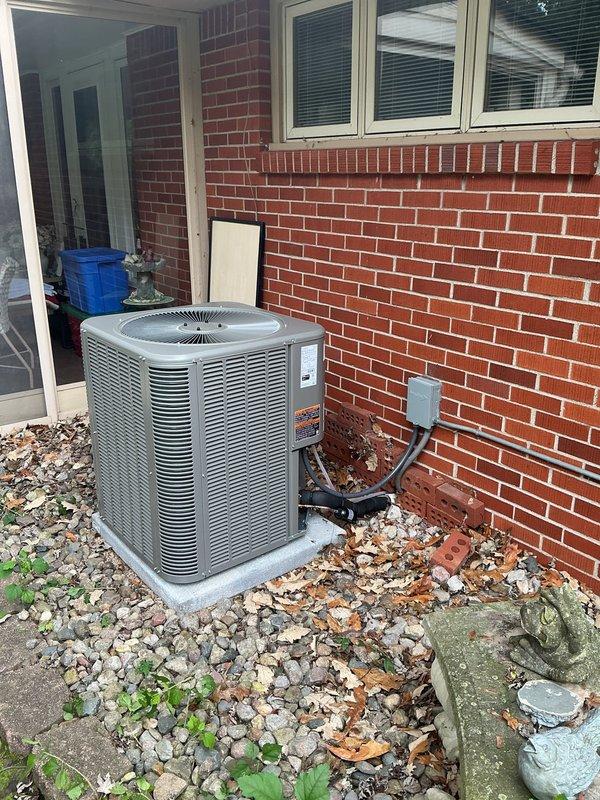 Installed a new complete split system consisting of a 96% AFUE, 90,000 BTU downflow gas furnace with matching cased evaporator coil, metal-supply plenum transition, and a 12-gallon humidifier, with PVC intake/exhaust venting and condensate drain piping routed and secured. Set a new single-stage air conditioning condenser on a new concrete pad and connected it with a new 3/4" x 50' insulated refrigerant lineset, a new electrical disconnect, and a flexible conduit whip. Installed a Wi-Fi thermostat to complete the system controls.