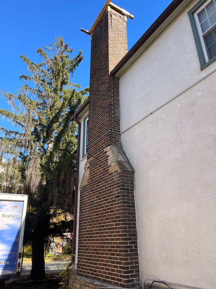 Rebuilt 3 courses of brick and poured new crown  Rebuilt 3 courses of brick and poured new crown