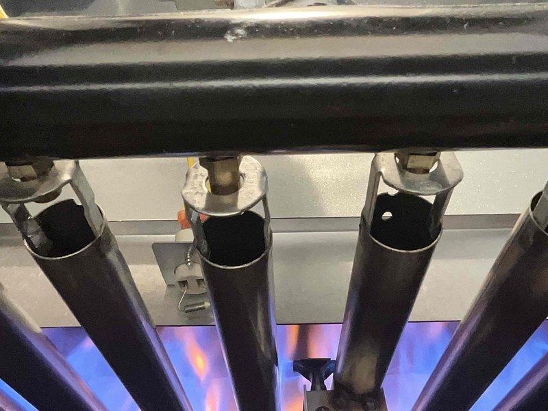Performed scheduled heating tune-up on customer's heat pump boiler system. Inspected heat exchanger which showed signs of significant oxidation and mineral buildup. Observed burner assembly functioning properly with normal flame pattern. System operational at conclusion of service.