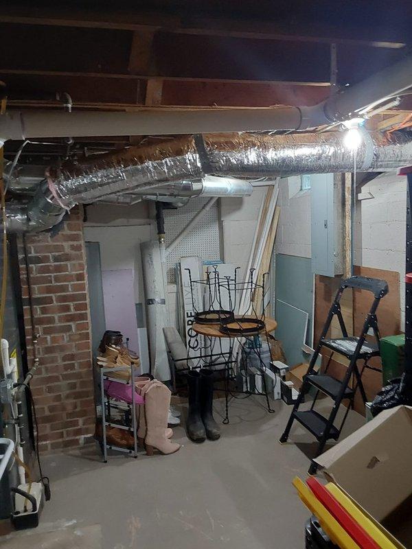 Successfully installed new ductwork to provide heating to a 4-season room by running a 7" flex duct connection through an existing glass block window. Completed installation included mounting a 4"x12"x7" straight boot with damper, securing 7" start collar, installing approximately 60" of 30-gauge ductwork, and finishing with a 4"x12" white register in the room for proper air distribution.