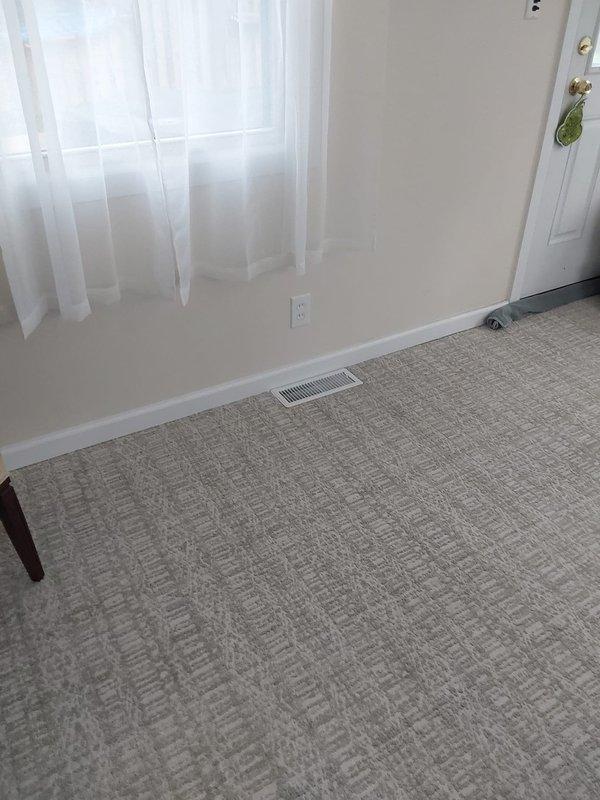 Successfully installed new ductwork to provide heating to a 4-season room by running a 7" flex duct connection through an existing glass block window. Completed installation included mounting a 4"x12"x7" straight boot with damper, securing 7" start collar, installing approximately 60" of 30-gauge ductwork, and finishing with a 4"x12" white register in the room for proper air distribution.