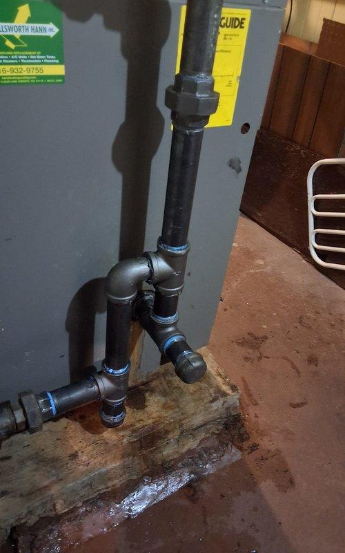 Replaced compromised nipple in steam boiler return line, addressing leakage evident by rust staining on floor. Retained and reconnected serviceable components of the original piping configuration, ensuring proper seal at all connection points using appropriate thread sealant.