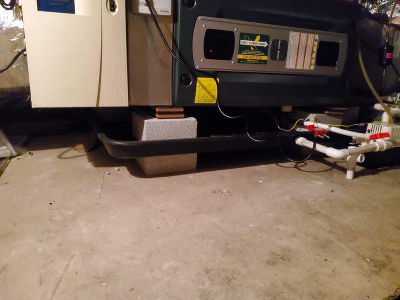 Inspected HVAC system with water leak originating from improperly installed humidifier without adequate drainage for emergency pan. Consulted with Dale Salo regarding proposed solution to replace damaged humidifier and modify drain pan configuration by raising it to connect with dedicated condensate pump. Noted that complete resolution of all drainage issues would require full equipment replacement.