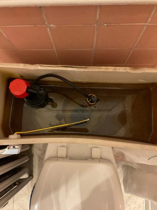 Responded to service call for toilet tank malfunction. Upon inspection, found internal tank components showing significant wear and mineral buildup. Replaced damaged flush valve mechanism to restore proper toilet function.