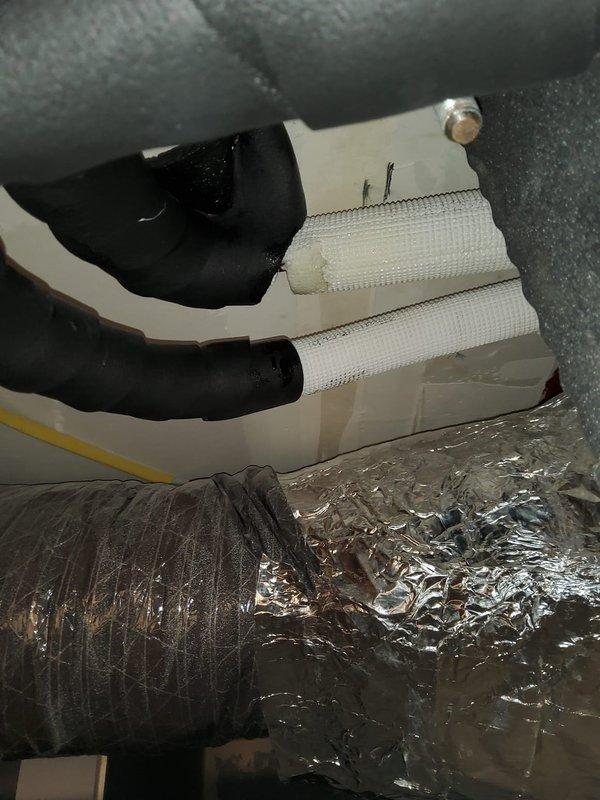 Responded to commercial building service call for J.M.K. furnace not producing heat. Thermostat limited to 63°F maximum. Discovered oil leak in mini-split system requiring insulation repair. Completed ductwork insulation replacement and sealed exposed connections with foil tape to restore proper system operation.
