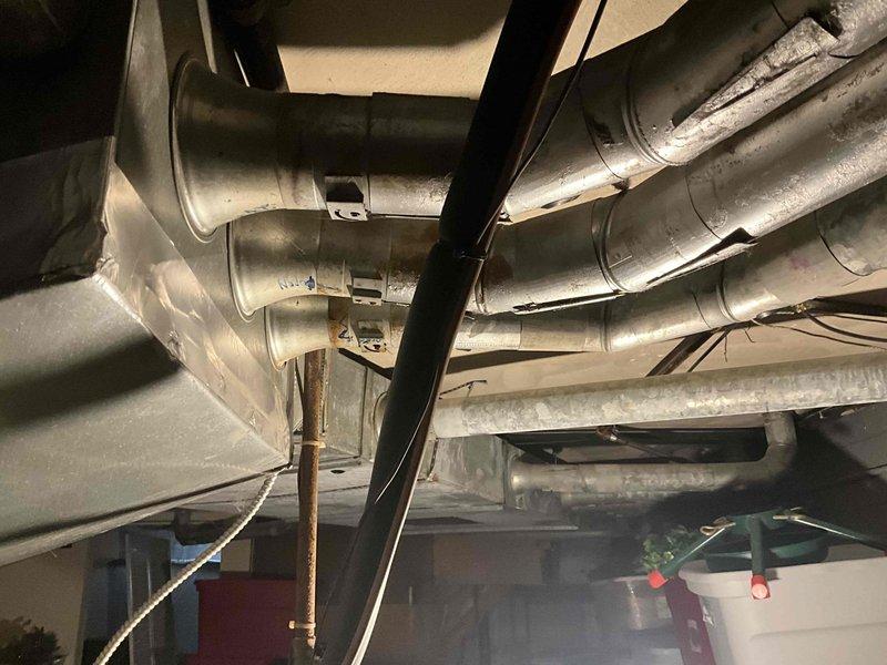 Performed diagnostic inspection on 20-year-old furnace with reported cracked heat exchanger and overheating issues. Visual assessment confirmed aging unit with deterioration and internal component wear. Provided customer with replacement options for 90,000-100,000 BTU two-stage furnace system with humidifier, and included additional quote for AC replacement though not immediately critical.