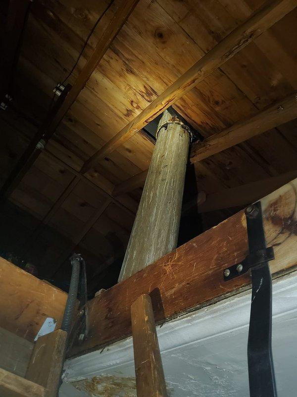 Responded to service call for furnace condensation leak. Inspection revealed significant corrosion and water damage at the metal-to-PVC transition in the exhaust flue system. Observed rust deterioration at the ceiling connection point with evidence of ongoing moisture issues. Structural inspection of surrounding support elements showed some water staining on wooden components, indicating prolonged exposure to condensation.