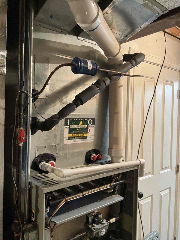 Conducted diagnostic inspection on furnace system reporting loud squeaking noise during operation. Visual assessment of the complete HVAC installation including furnace unit, PVC ventilation piping, and ductwork revealed worn bearings in the blower motor assembly. Recommended full system replacement due to age of equipment and potential for cascading component failures.