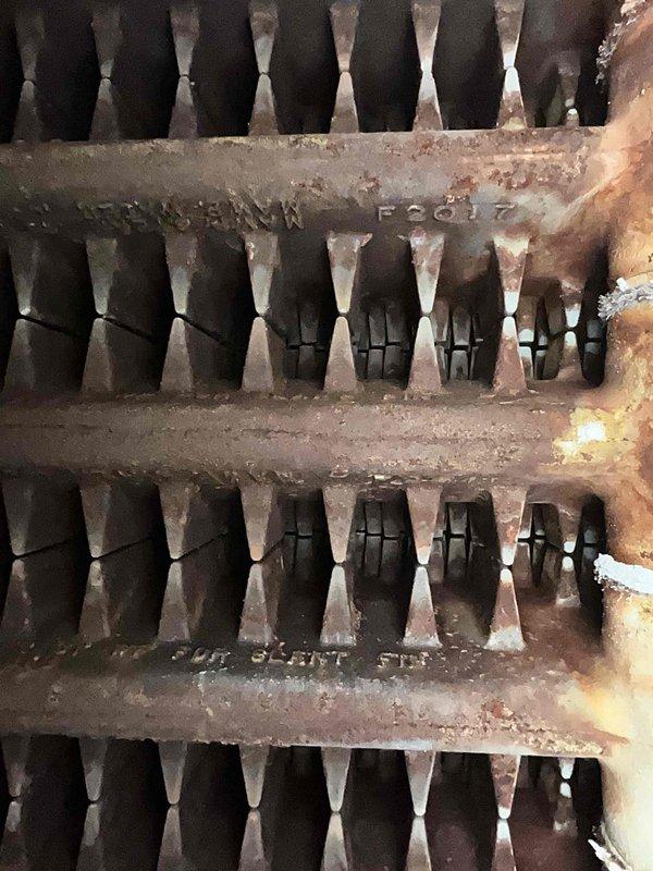 Performed scheduled boiler tune-up service on steam gas boiler system. Inspected heat exchanger which showed signs of aging with oxidation and mineral deposits. Verified proper burner operation with normal blue flame pattern indicating efficient combustion.