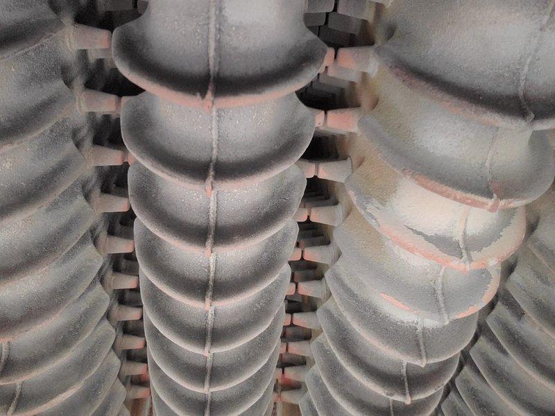 Performed scheduled maintenance on customer's boiler system per renewal plan. Inspected cast iron heat exchanger components for corrosion and wear, noting minor surface oxidation along seams. Examined electrical connections and ceramic insulators, confirming proper condition with no signs of damage or deterioration.