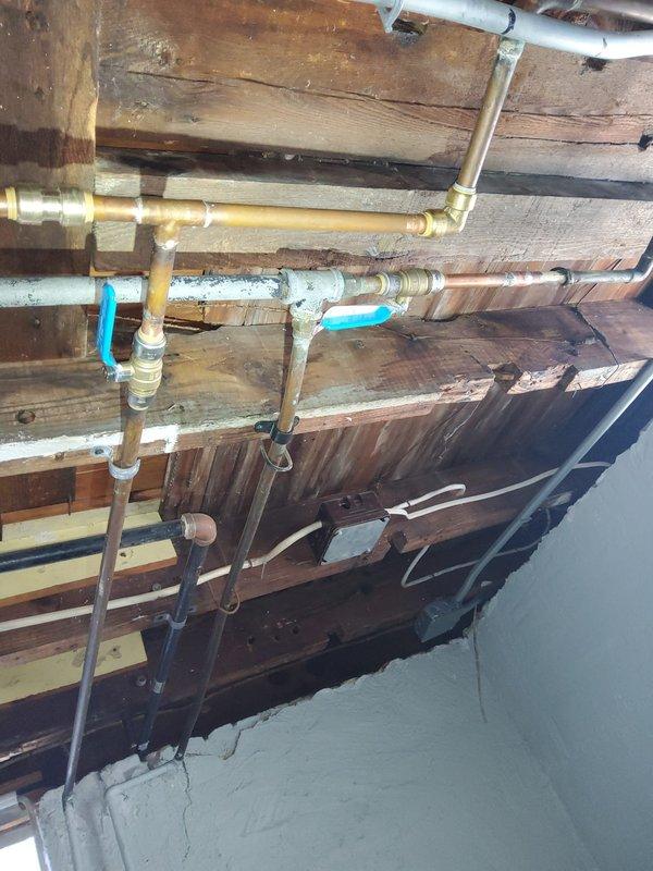 Diagnosed and repaired slow water leak from copper pipe in basement by resoldering compromised joints. Identified connection points with brass fittings showing signs of previous inadequate work. Inspected complete plumbing system including bathtub drainage issue and low water pressure problem, making necessary adjustments to restore proper functionality.