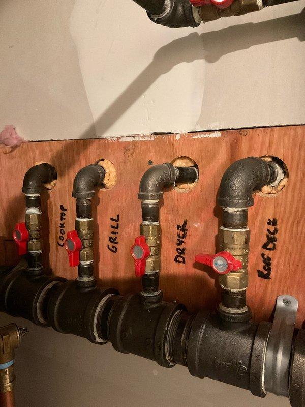 Responded to service call regarding gas leak. Upon inspection, identified a loose connection at the brass valve on the main gas line where it connects to the distribution manifold. Tightened the connection, applied appropriate pipe sealant, and pressure tested the entire system including connections to the grill, dryer and deck outlets. All valves and fittings now secure with no detectable leaks.