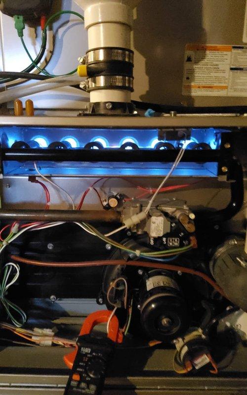 Performed preventative maintenance on 10-year-old MVP gas furnace. Inspected burner assembly confirming proper flame pattern with consistent blue flames. Conducted diagnostic testing with multimeter to verify electrical components functioning within specifications. Visual inspection of exhaust/intake PVC ventilation system showed proper installation with no apparent issues.